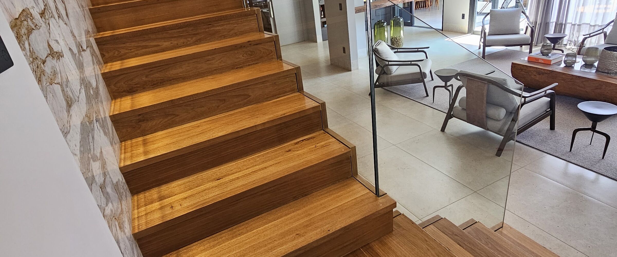 Escada de madeira restaurada ao lado da sala de estar